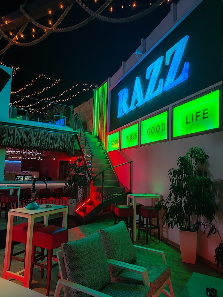 Inside Razz beneath the neon sign